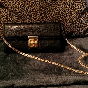 Faux leather crossbody bag with gold chain strap.